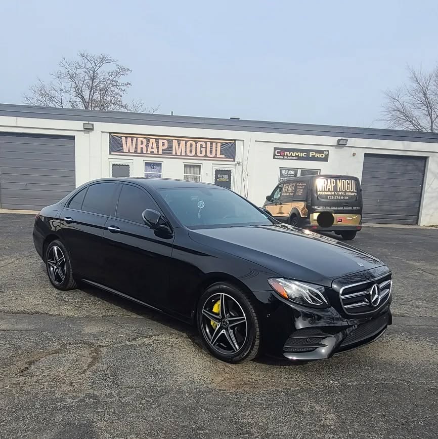 Black Mercedes with ceramic coating, paint correction, and yellow calipers by Wrap Mogul